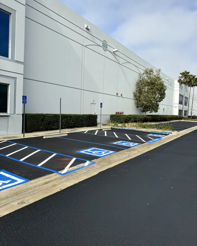 Commercial lot with fresh asphalt and new accessible parking stalls